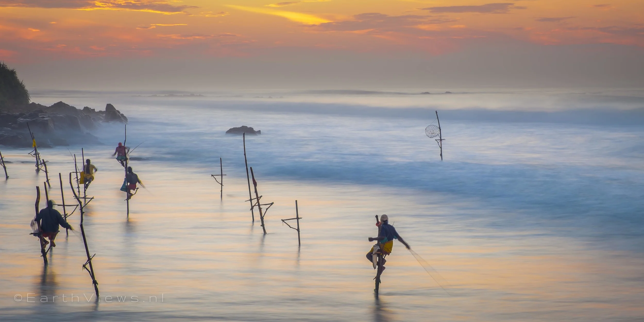 Stilt fishermen at the beach of Weligama, Sri Lanka.