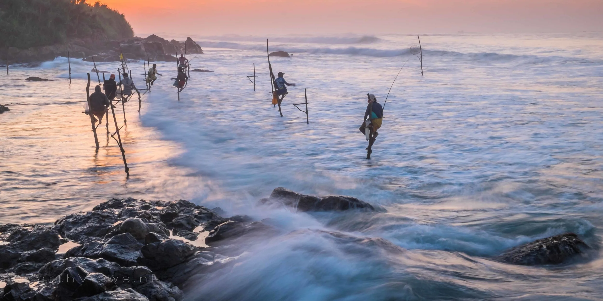 Stilt fishermen at the beach of Weligama, Sri Lanka.