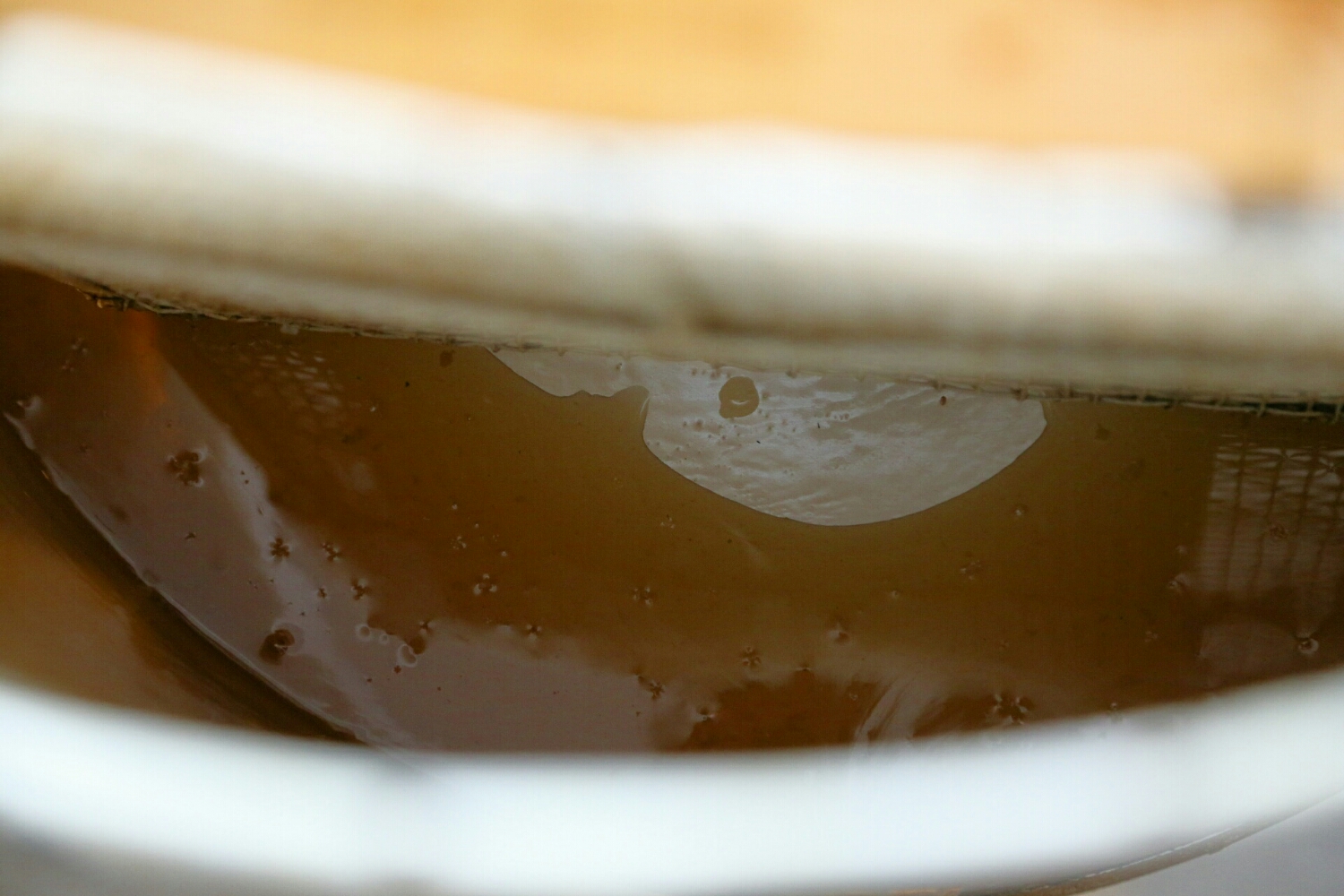 Honey collecting at the bottom of the drum.