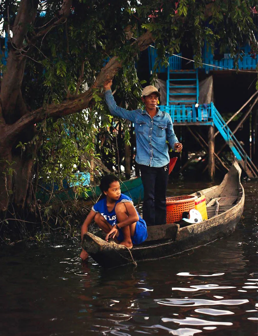 Father and Daughter outside their Home at The Floating Village, Cambodia.