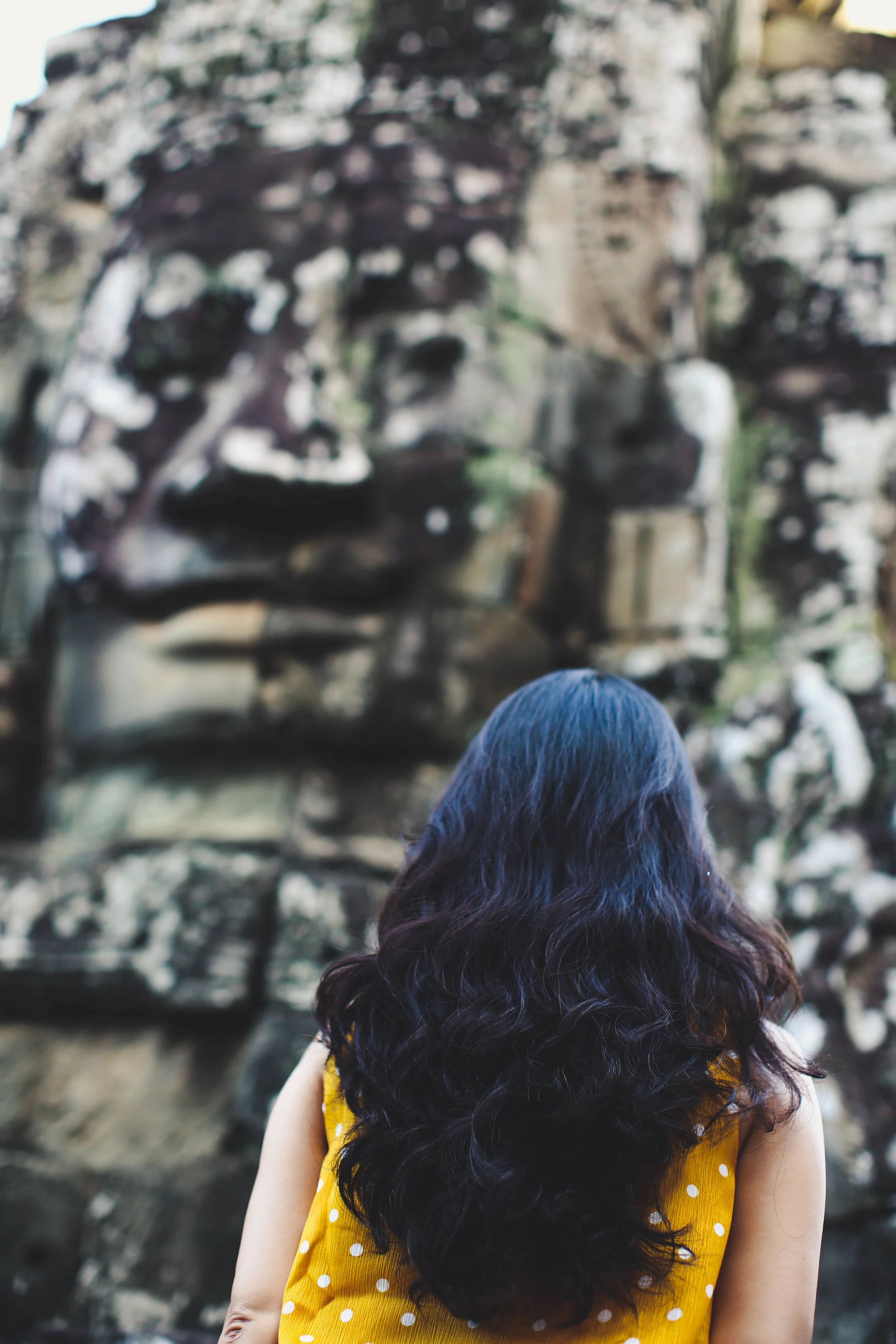 A Woman Admiring the beauty of Bayon Temple. Siem Reap, Cambodia