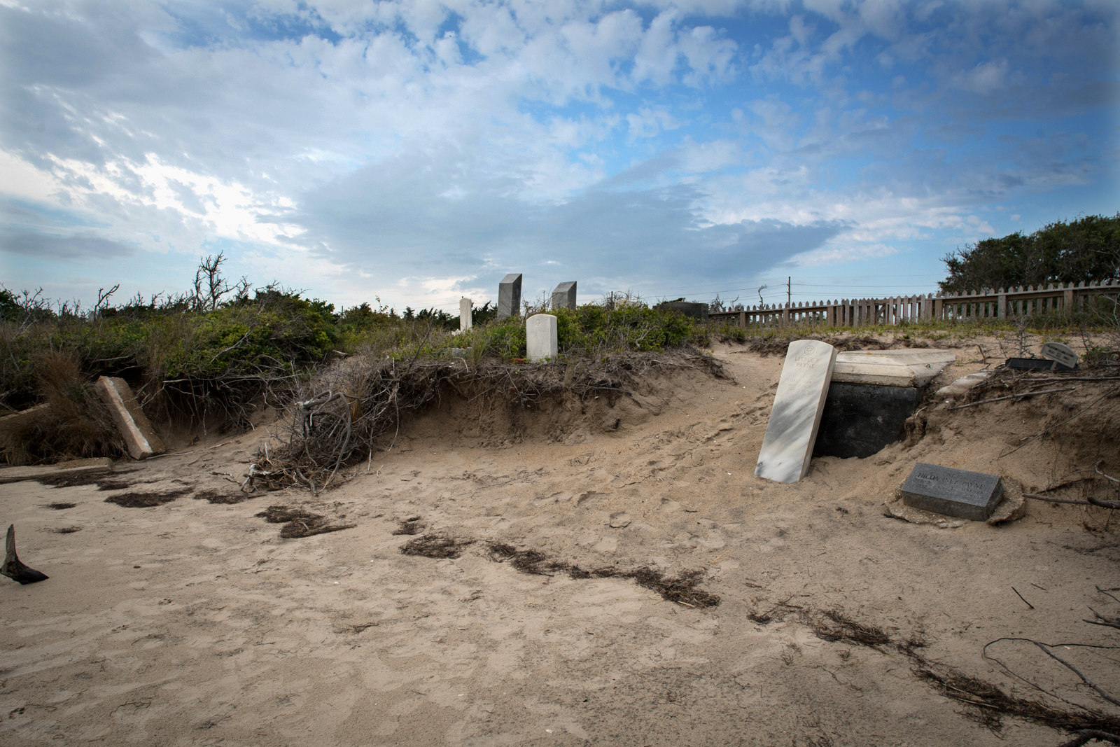 A private graveyard is slowly claimed by erosion and high waters in the Salvo Day Use Area on Cape Hatteras National Seashore. It is surrounded on three sides by national park land and Pamlico Sound on the other. The North Carolina gravesite existed long before the area became a park in 1965.