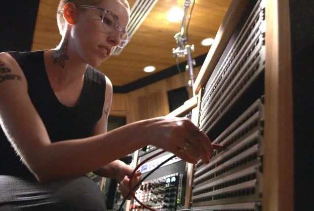 Women's Audio Mission girl using patchbay
