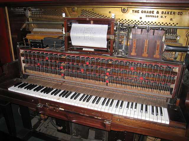 ... and a vintage mechanical player piano showing the roll-reading mechanism. 