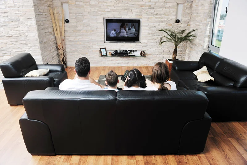 Family watching TV at home