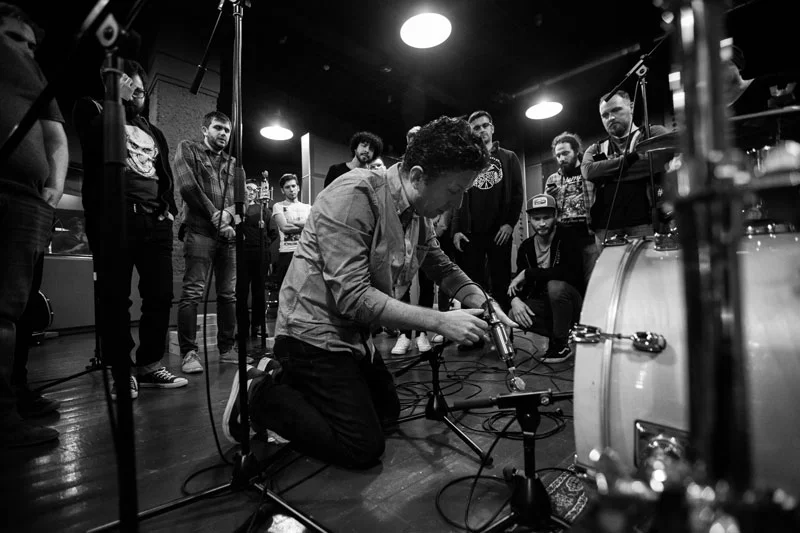 Setting the mics on the drums.