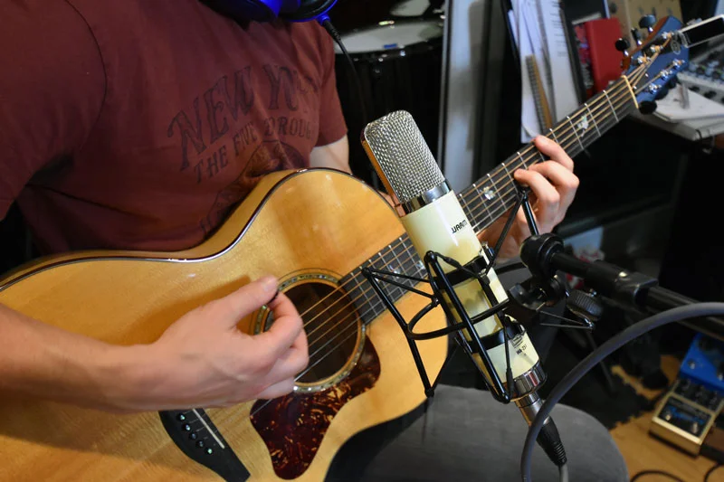 Warm Audio WA-251. Just above the sound hole of the steel string acoustic guitar.