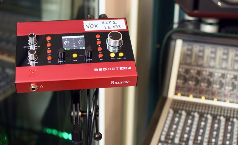 Focusrite Rednet X2P mounted on a mic stand ready for vocal monitoring duties.