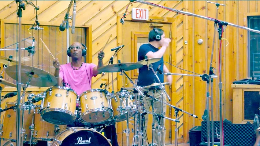 Look at where Omar Hakim’s overheads are. Definitely either side of an axis running through the kick and snare.