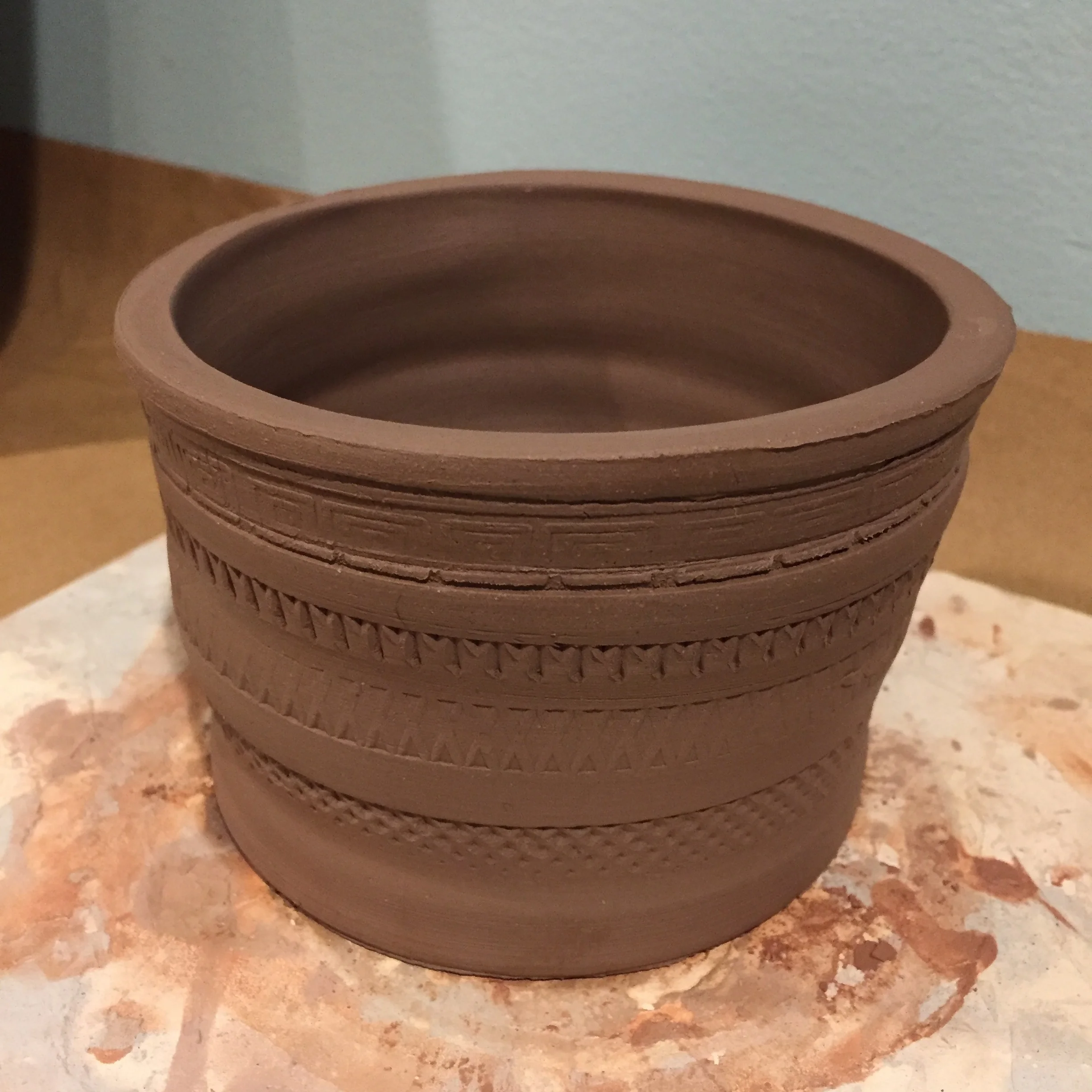 Wheel thrown pot made with stamped designs.