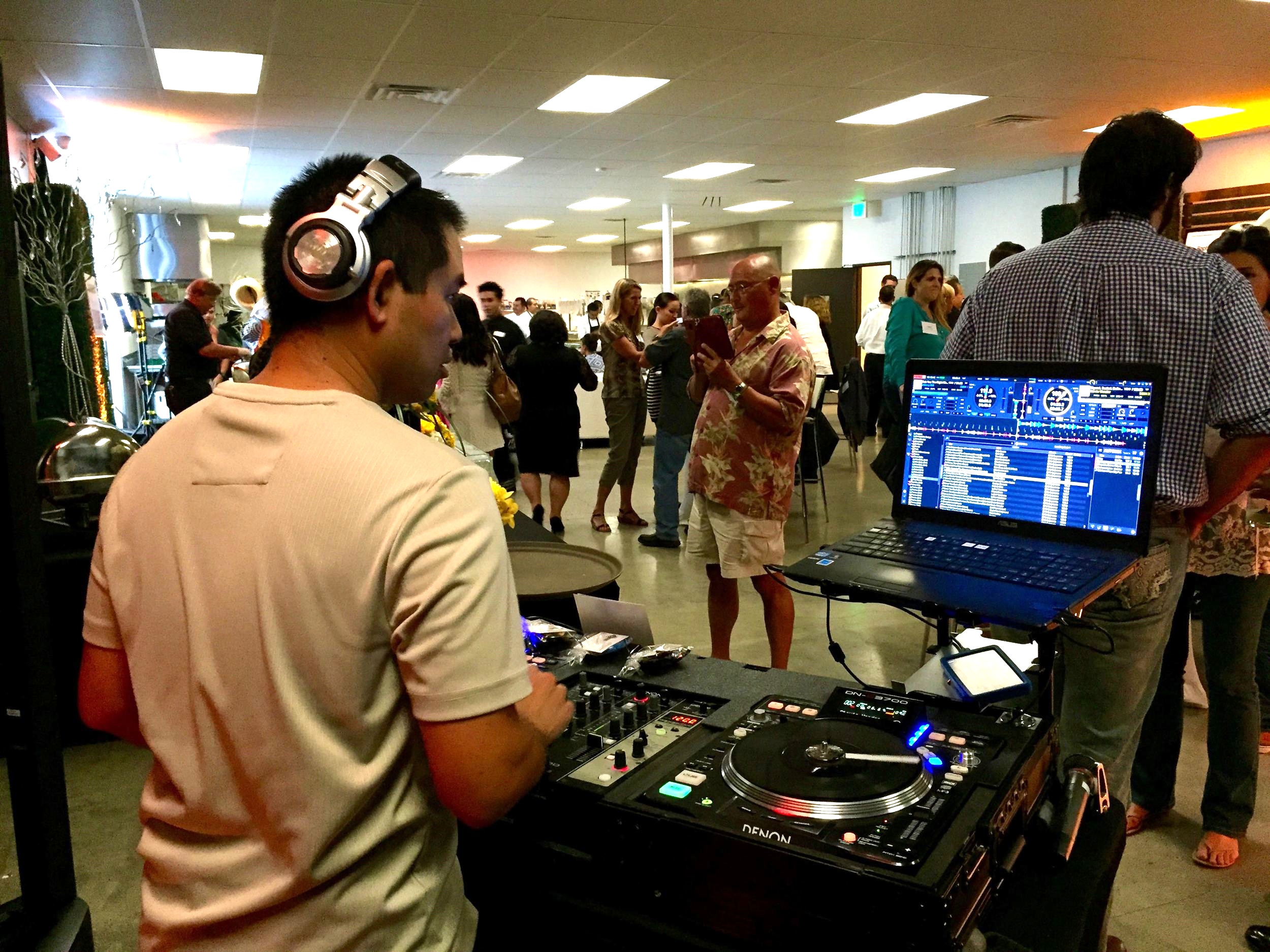 DJ Justin Kanoya provides live DJ service at the Brothers Signature Catering and Events grand opening party in San Diego, California. 