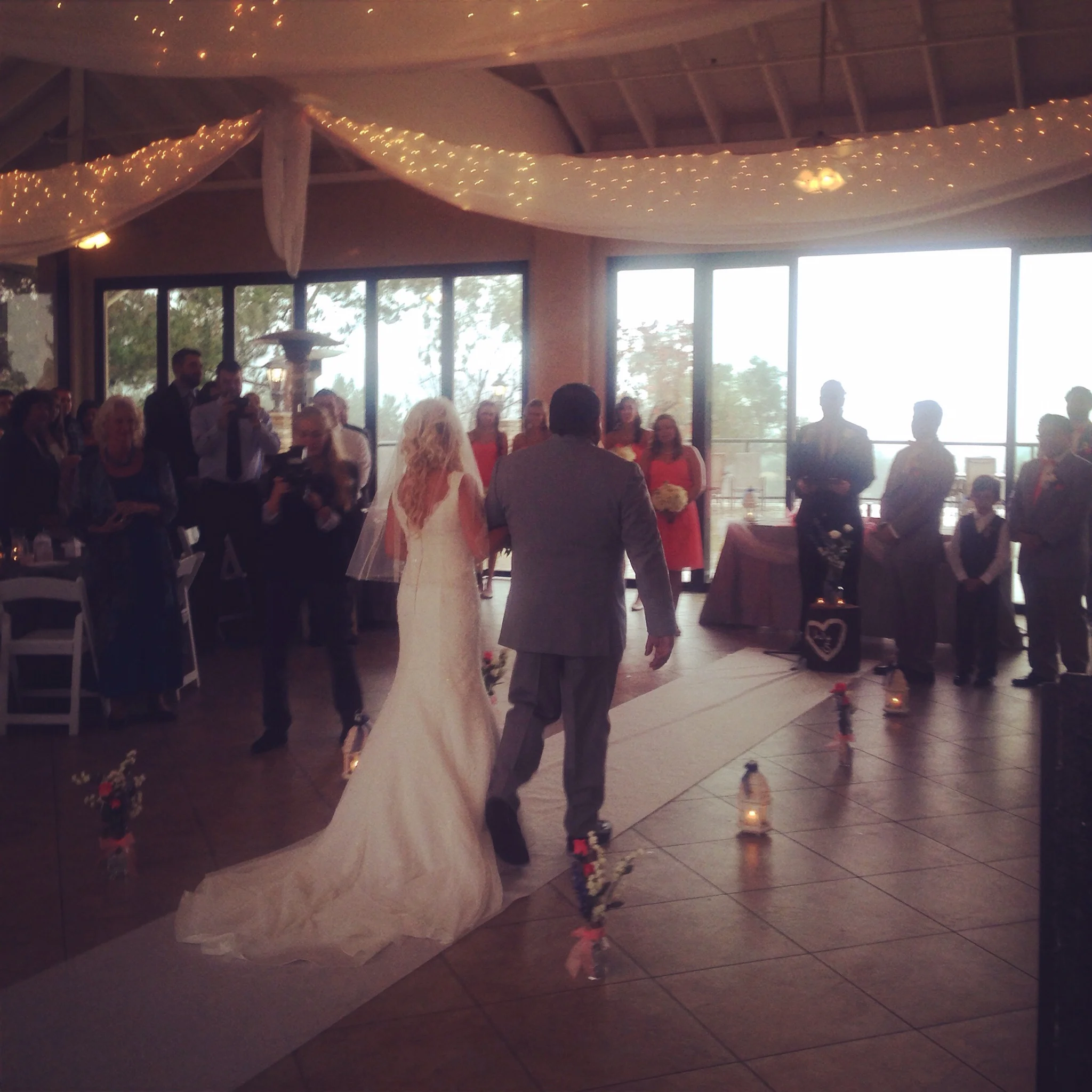 Samantha makes her way down the aisle toward a waiting William at Steele Canyon Golf Course.