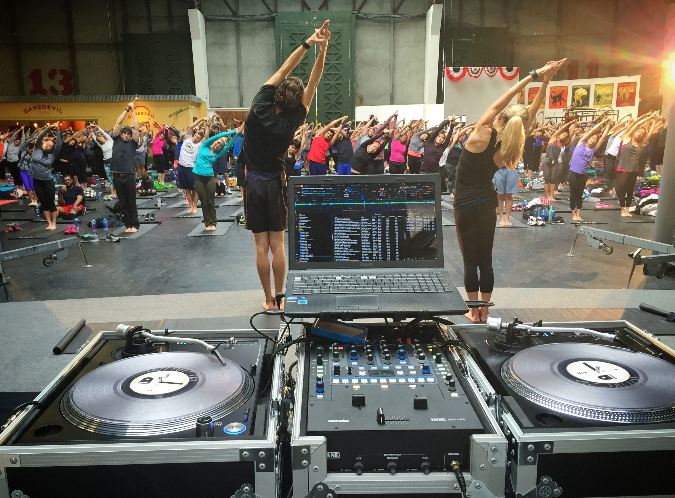 DJ Justin Kanoya plays music for a yoga event sponsored by Fitbit. 