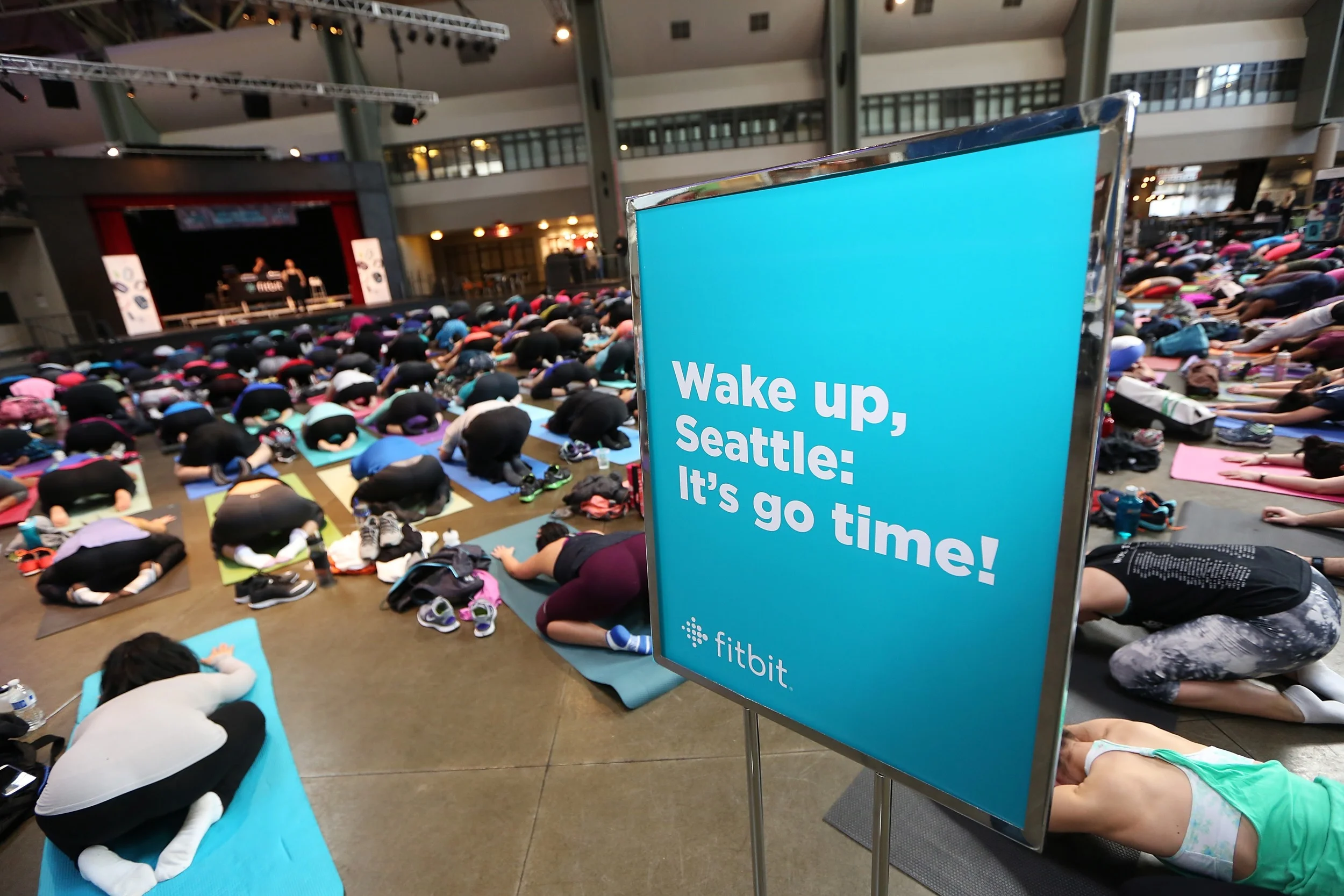 Fitbit Local Ambassadors Kaisa Keranen & Kevin Ng lead participants in a bootcamp and yoga workout as Fitbit Local Seattle launches with a free event at the Seattle Center Armory on March 26, 2016 in Seattle, Washington.