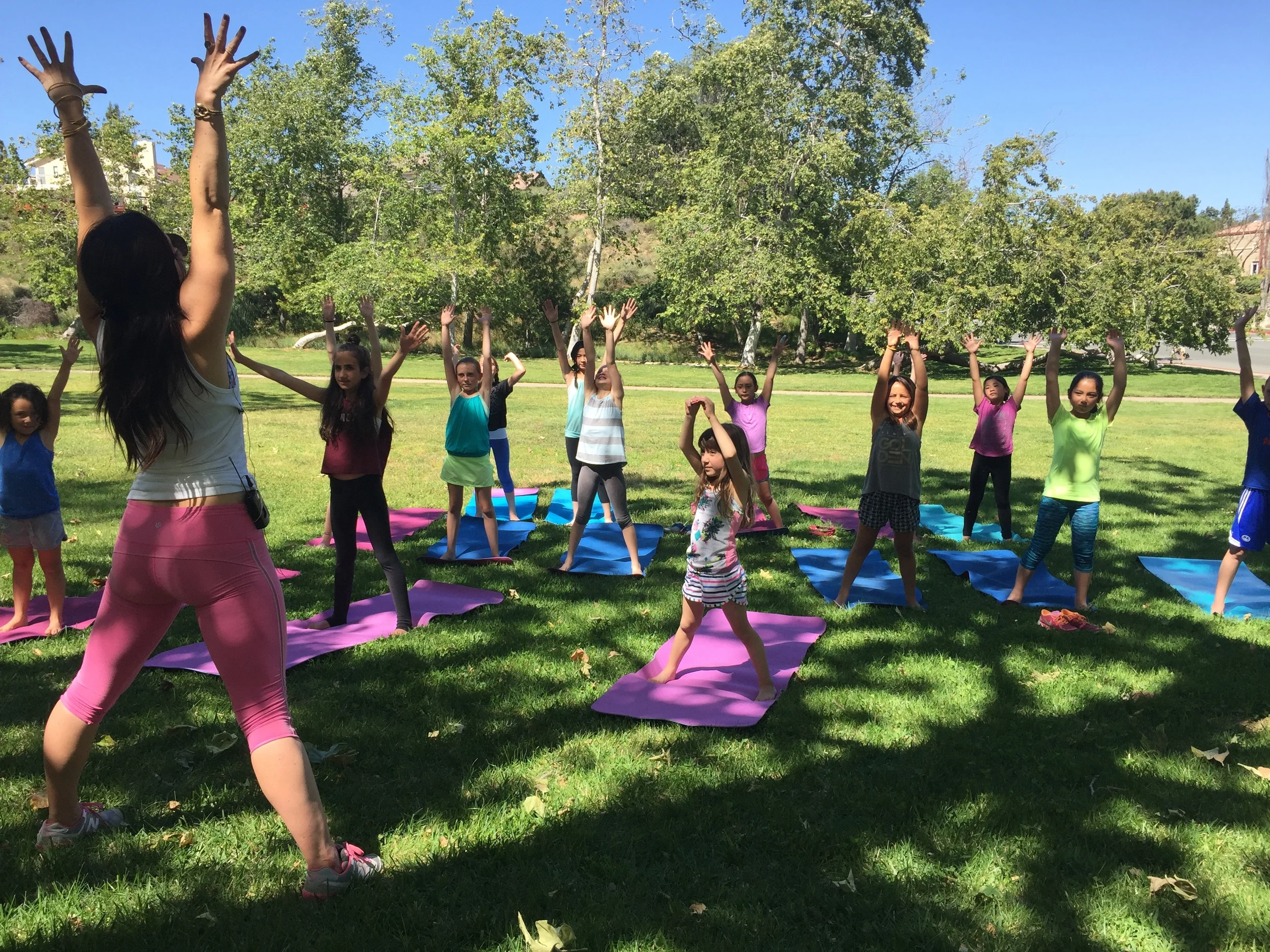 Instructor Lex Ferrier leads young girls through a yoga session at the Ivivva UTC Yogachella event. 