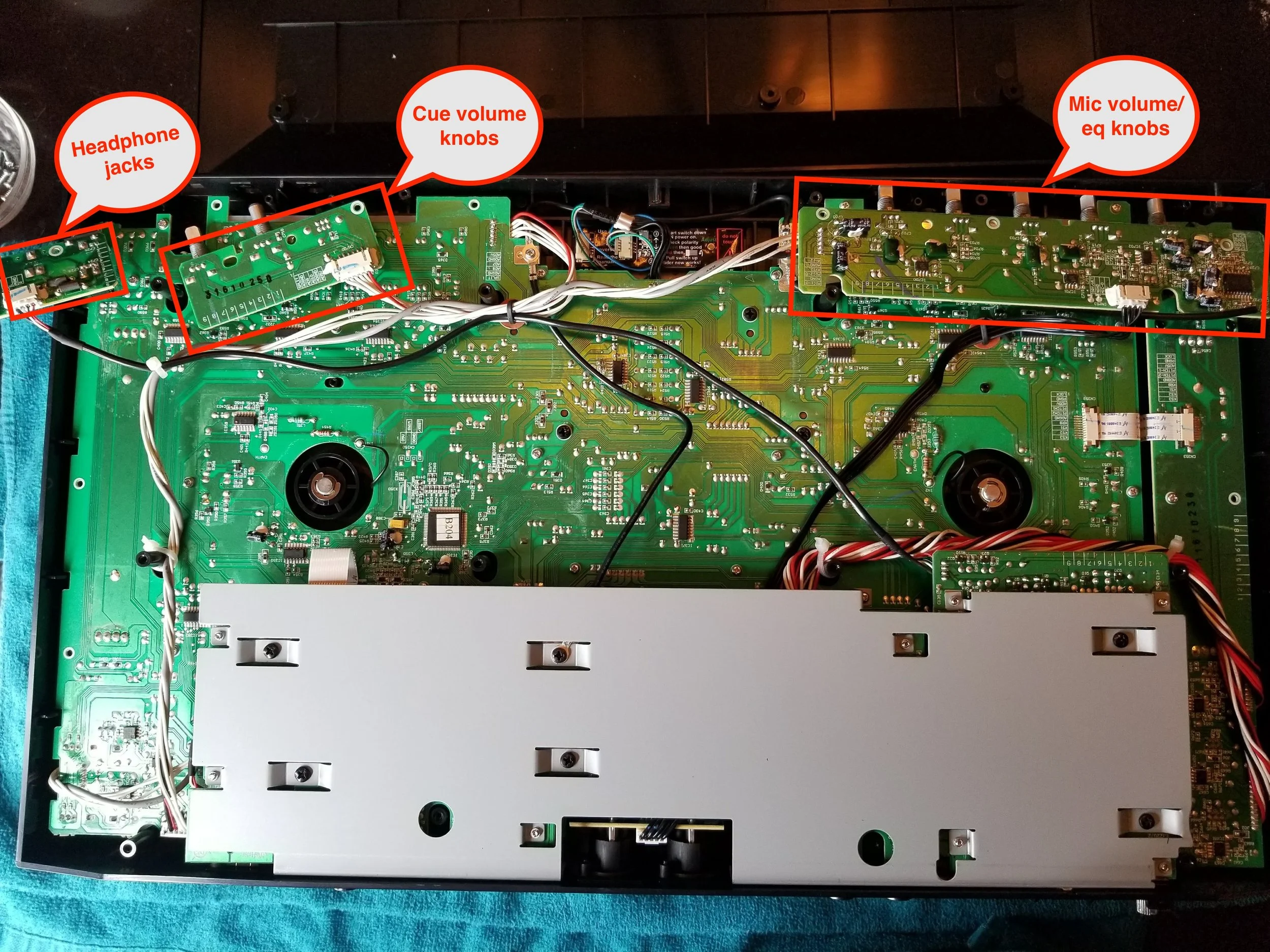 Removing these three circuit boards, held in place by small screws, is necessary to lift off the MC4000s faceplate and gain access to the crossfader. 