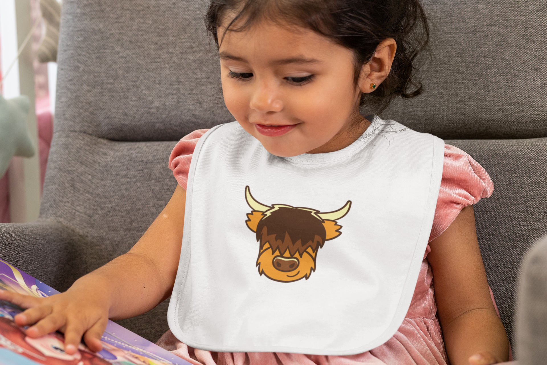 baby-bib-mockup-of-a-girl-looking-at-a-picture-book-32516 (1).png