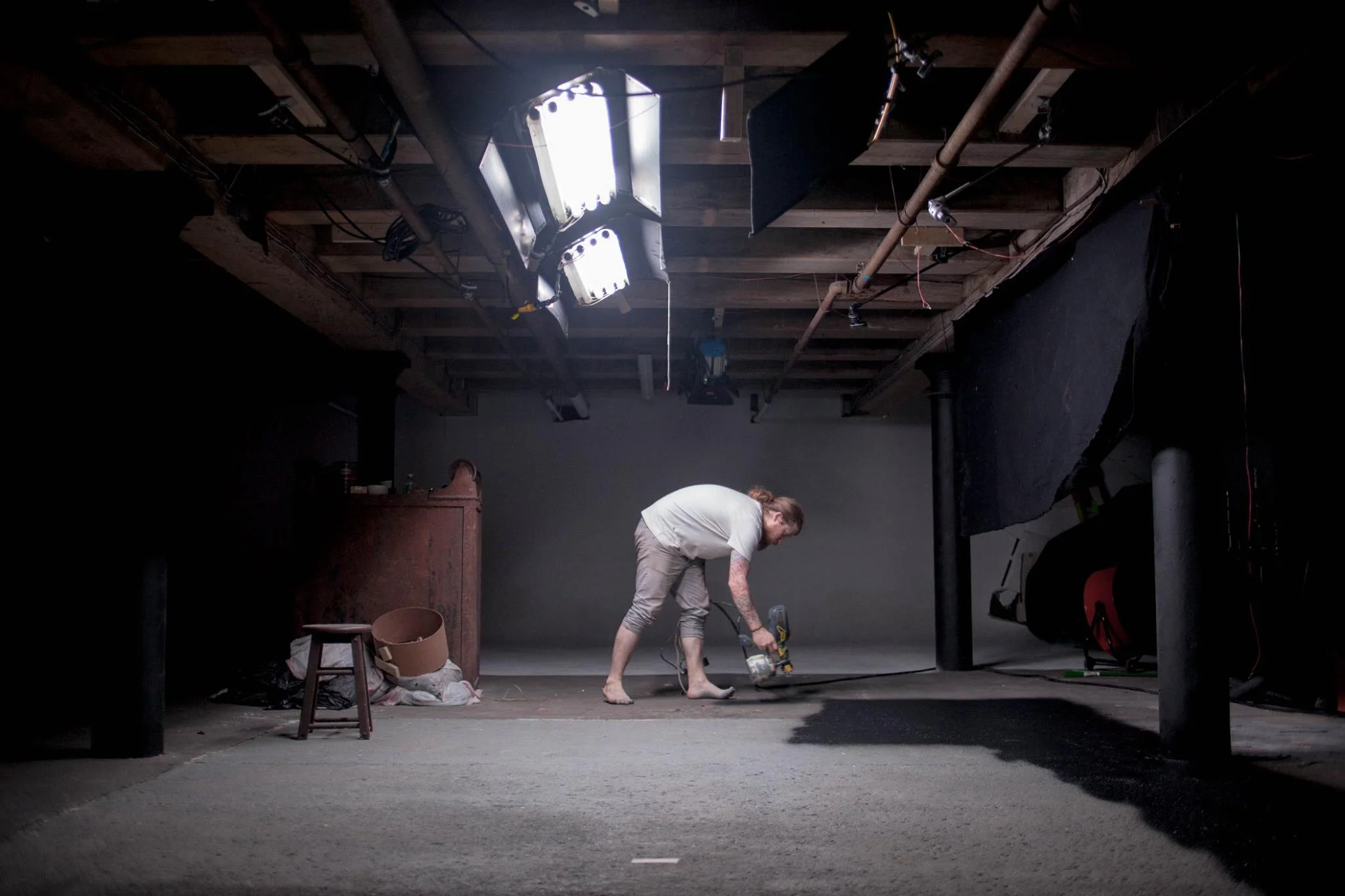 Cinematographer Jim DanDee paints the floor of The Space Studio black in preparation for the first day of production on LADIA. (Jim DanDee/Auspicious Phoenix Productions)