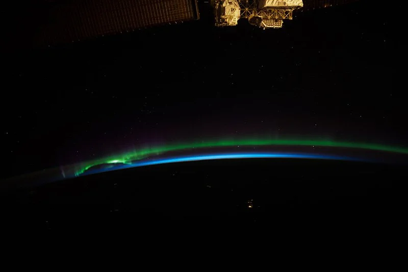Airglow and aurora dancing on Earth's limb