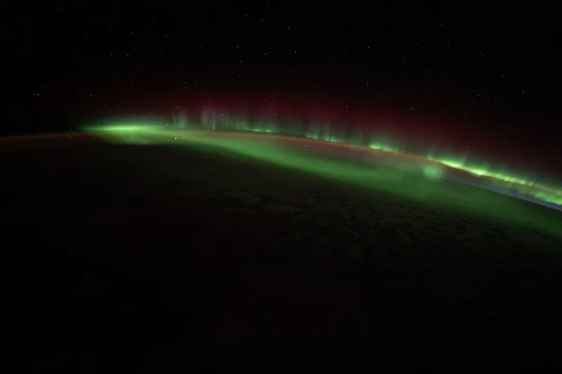 Aurora dancing on Earth with stars above