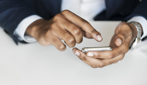 Closeup of businessman using mobile phone
