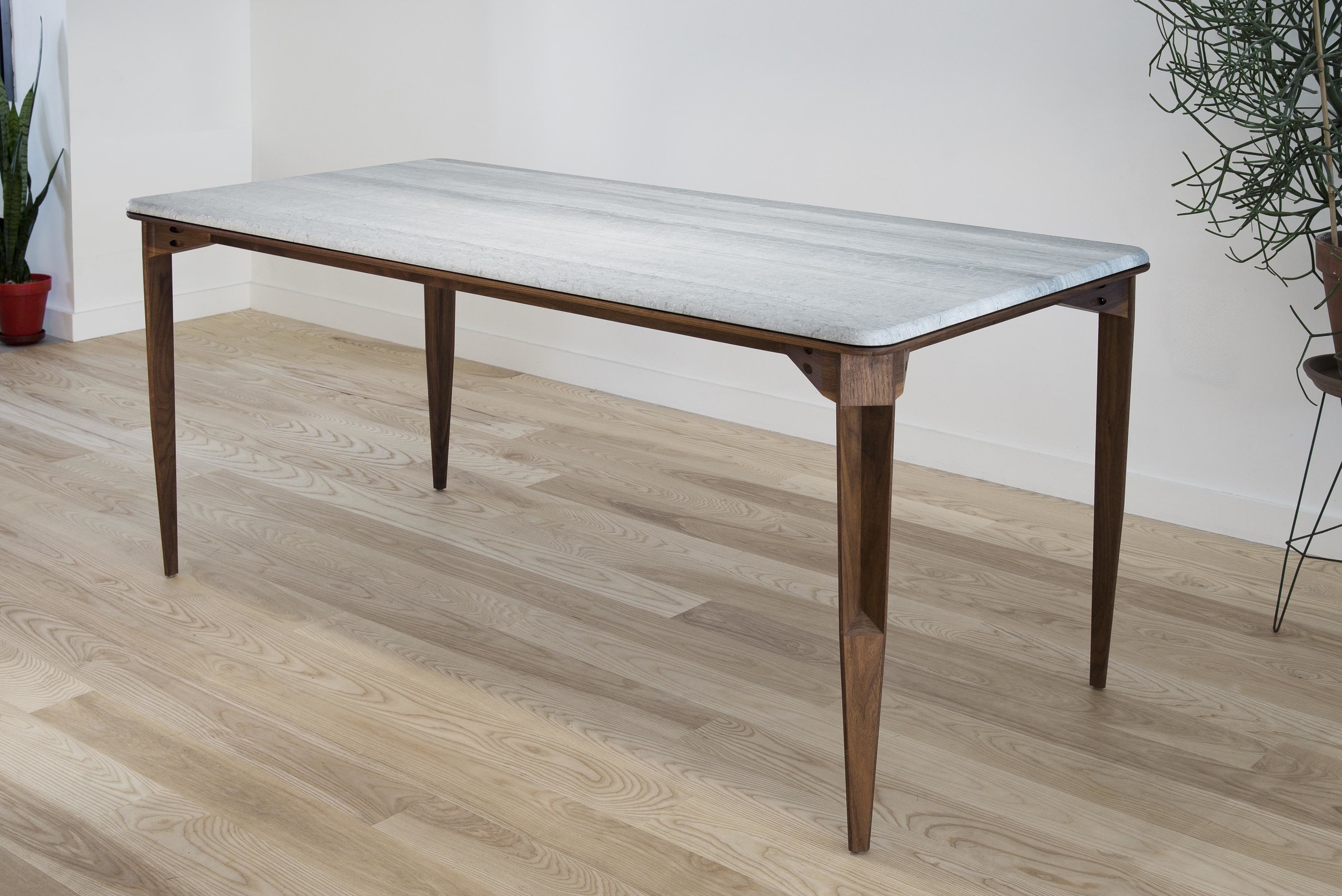 The table plays off the concept of a traditional frame but with the details of construction found on the exterior rather than concealed underneath.