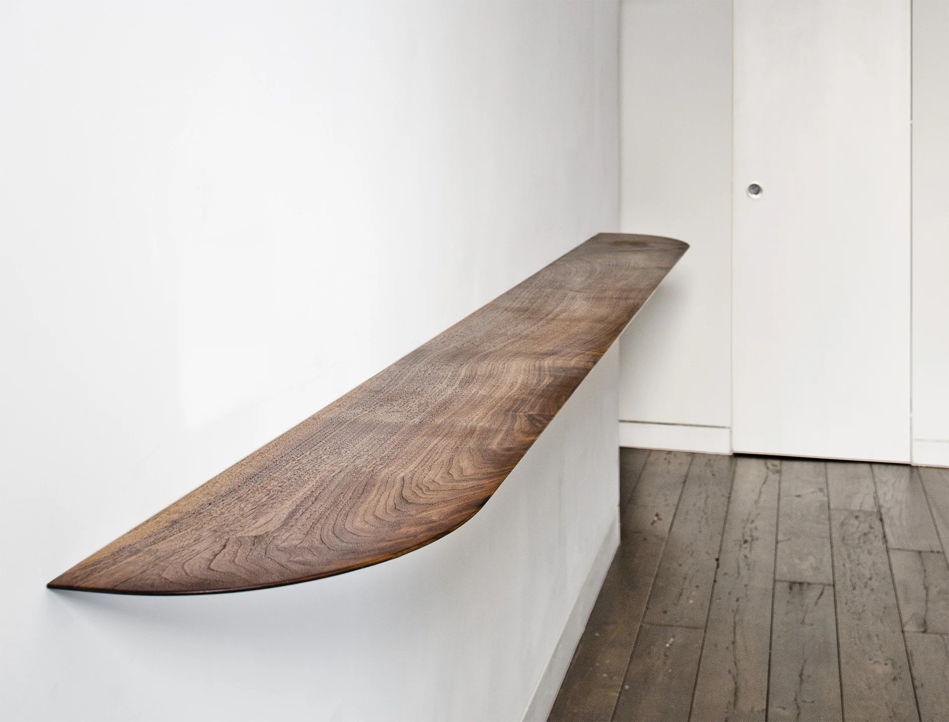  Our wall console is shaped from one 9' long piece of American Walnut and floated off the wall with hidden cleats.&nbsp; The edge profile is tapered to a thin edge to keep the form visually light.&nbsp; Custom installation for MdP Architects.&nbsp; C