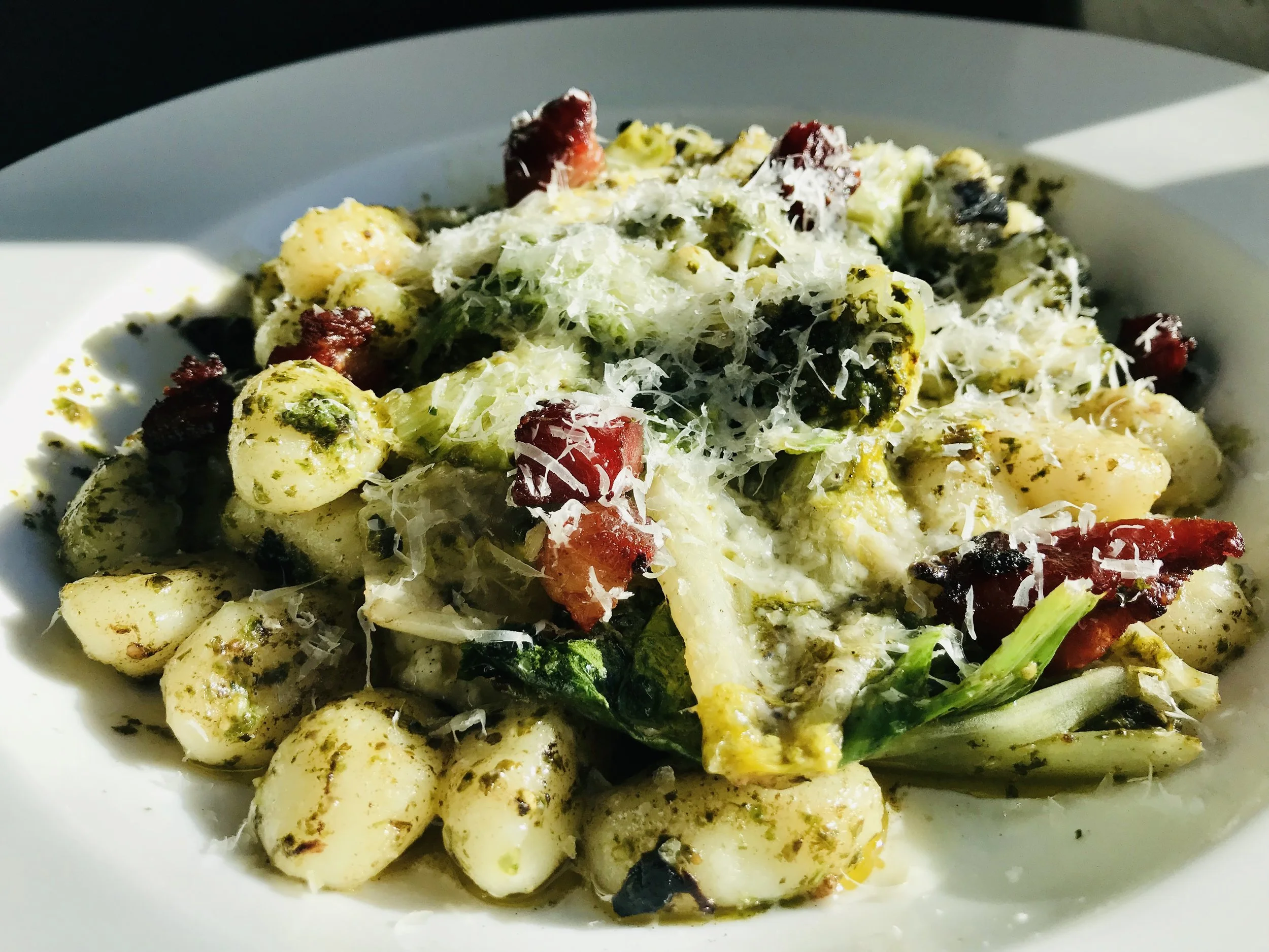 gnocchi with escarole, smoked bacon, goats ricotta, and pesto
