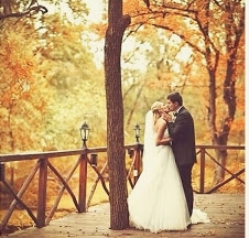 Couple Kissing Outside Among Fall Trees.jpg