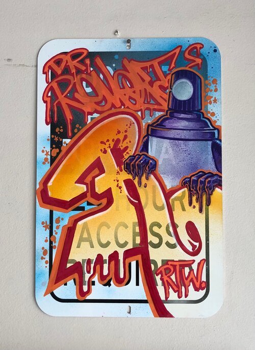 dr. revolt graffiti street sign