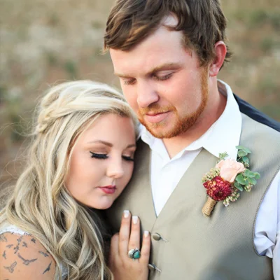 Bride and groom holding each other close.