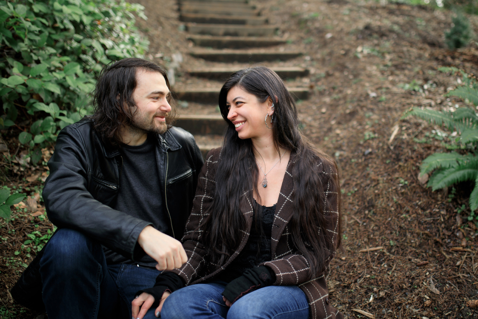  Man and woman smiling at each other on stair steps. 