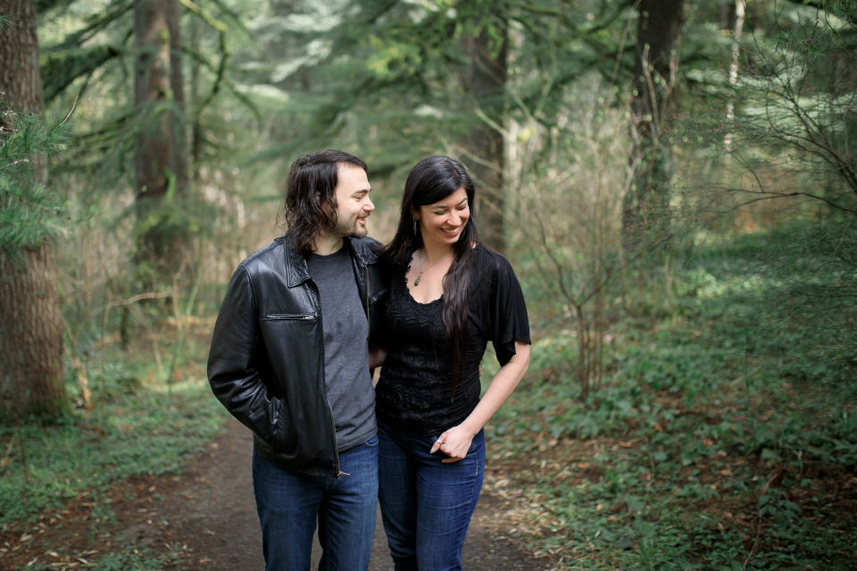  Woman laughing with man at a forest park. 