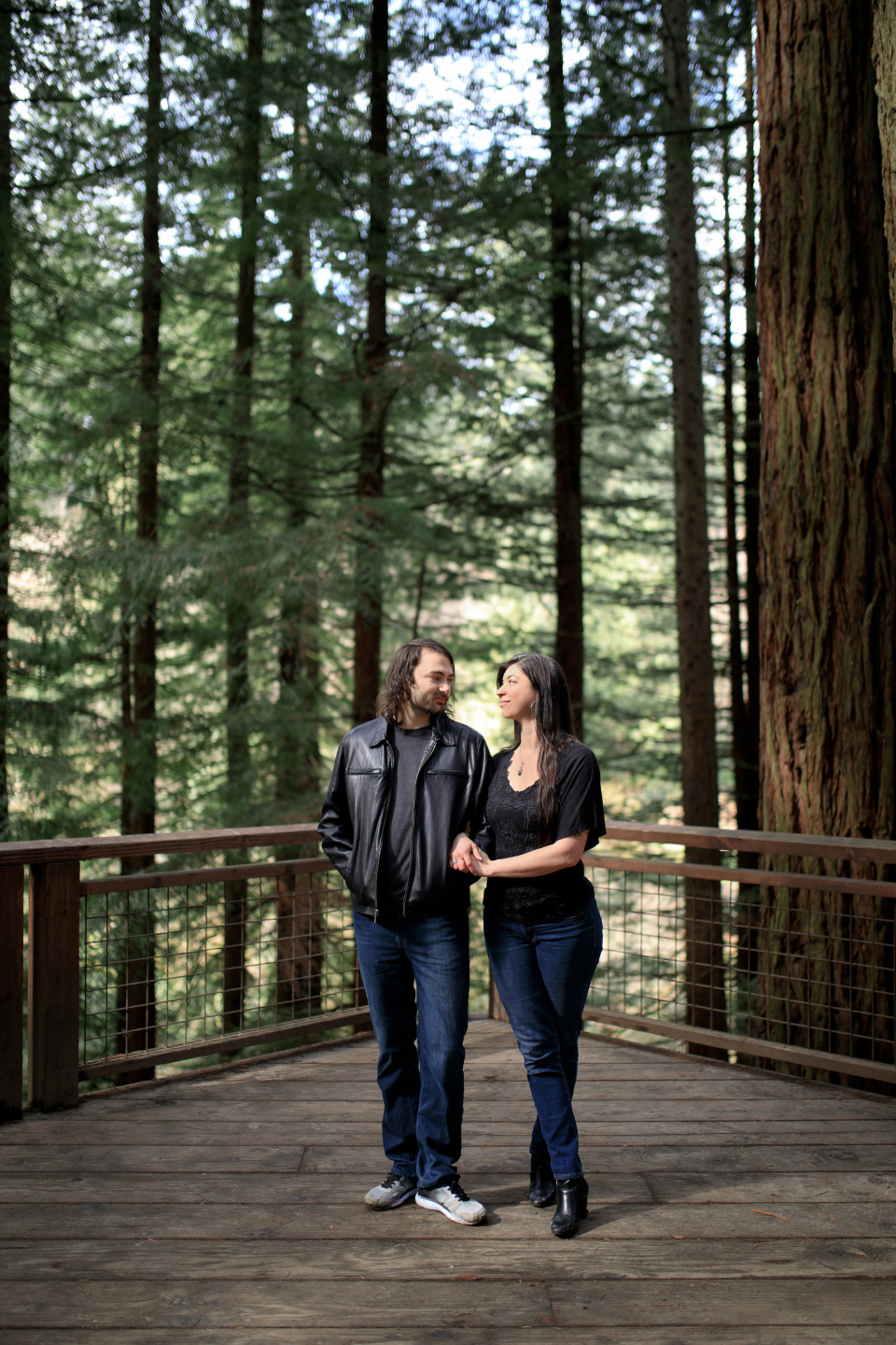  Man and woman looking at each other on the Redwood Deck. 