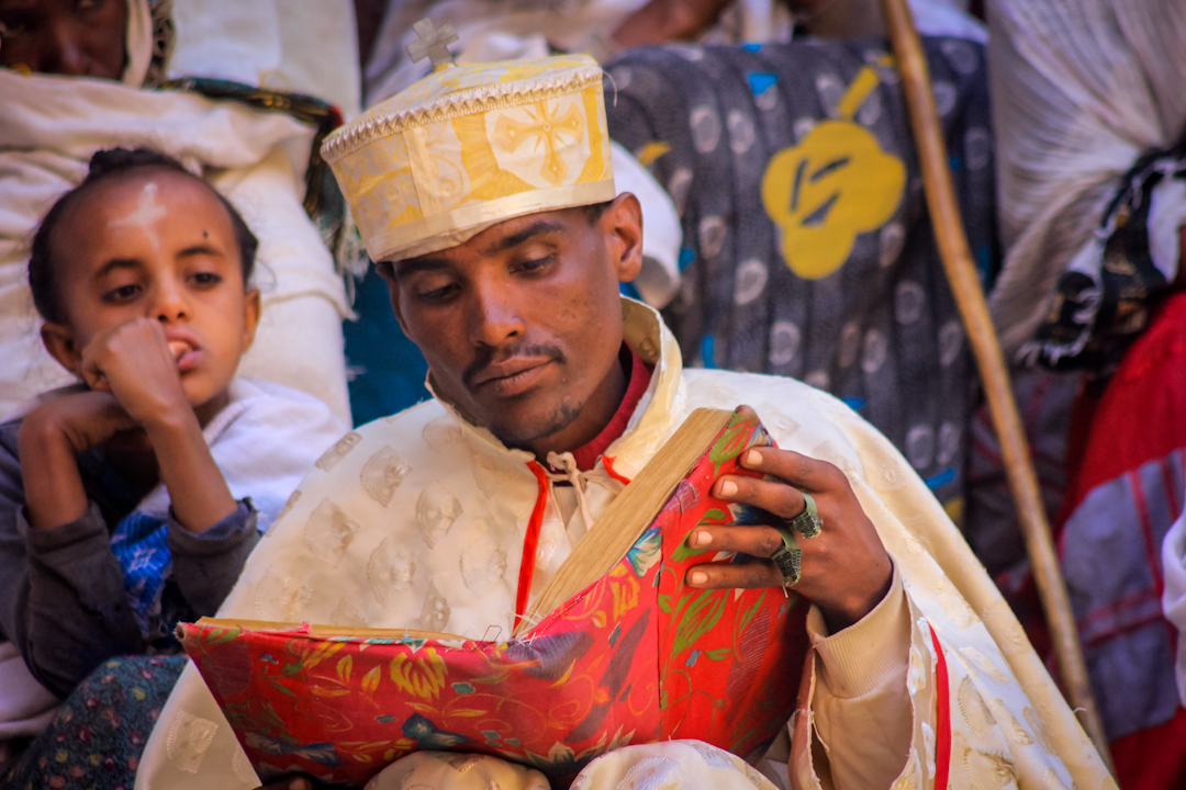 A DEACON studies scripture before a reading to hundreds of worshipers at the St. George church in Lalibela the week before Easter