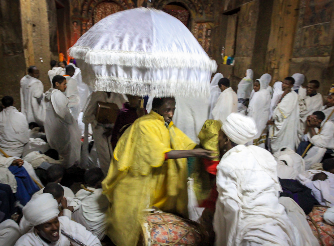 DEACONS tour the holy scripture for devotees to kiss, demarcating the end of fasting and the beginning of the Easter celebration