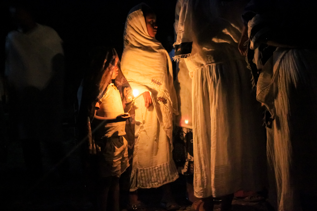 WEARY WORSHIPERS guide their way home with beeswax candles from Debre Birhan Selassie Church in Gonder on the night of “Fasika”
