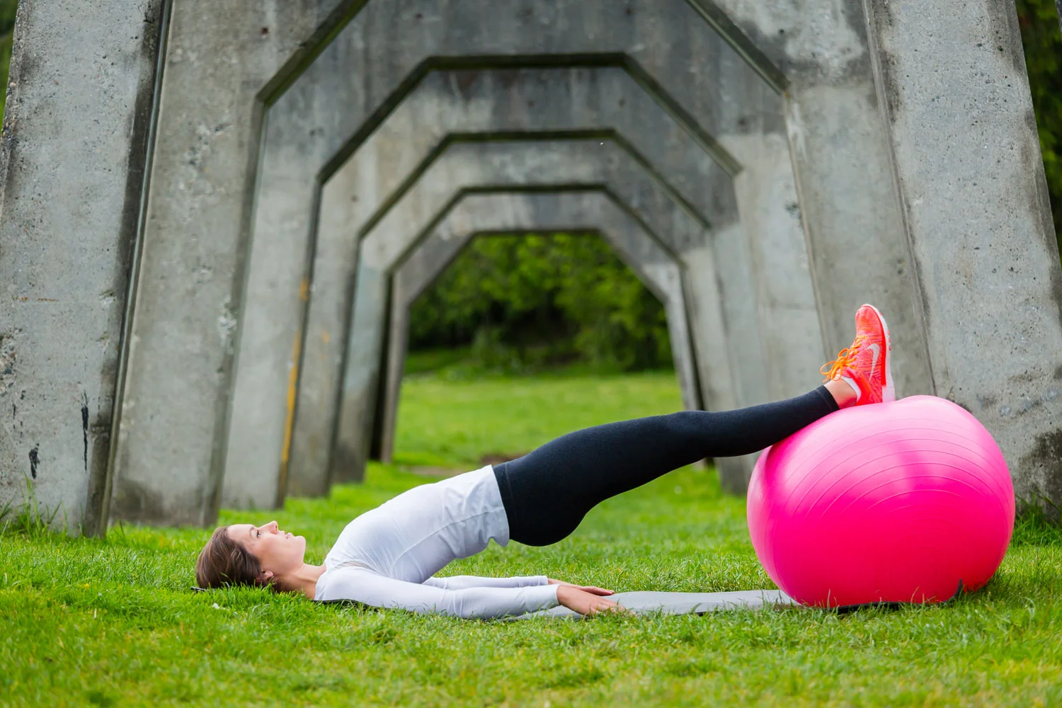 3. Hamstring Curls x20 - From bridge position with hips high, bend knees to bring ball towards rear. 