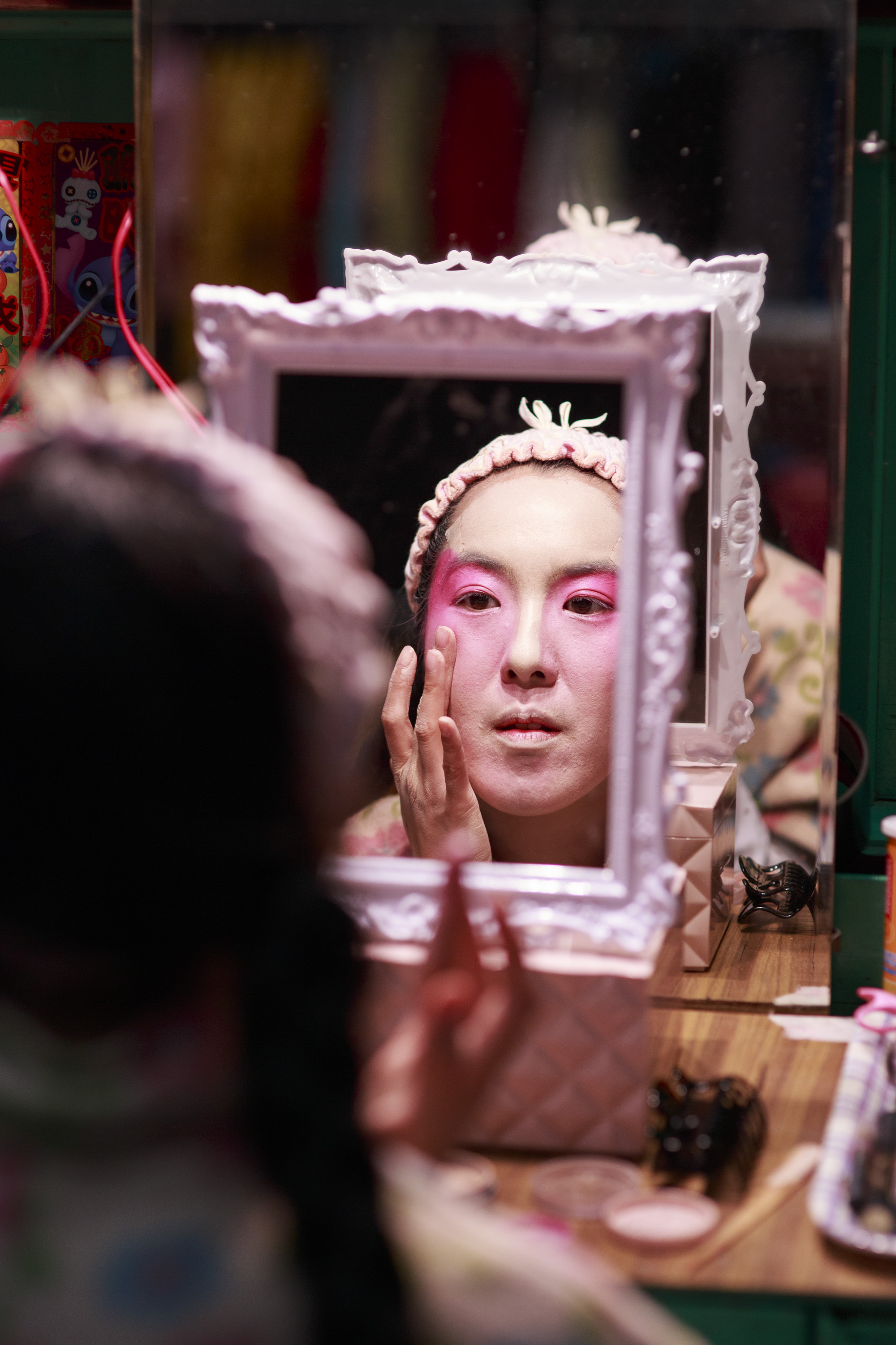  Eliza Li, Chinese Opera singer seen here applying makeup for her performance 