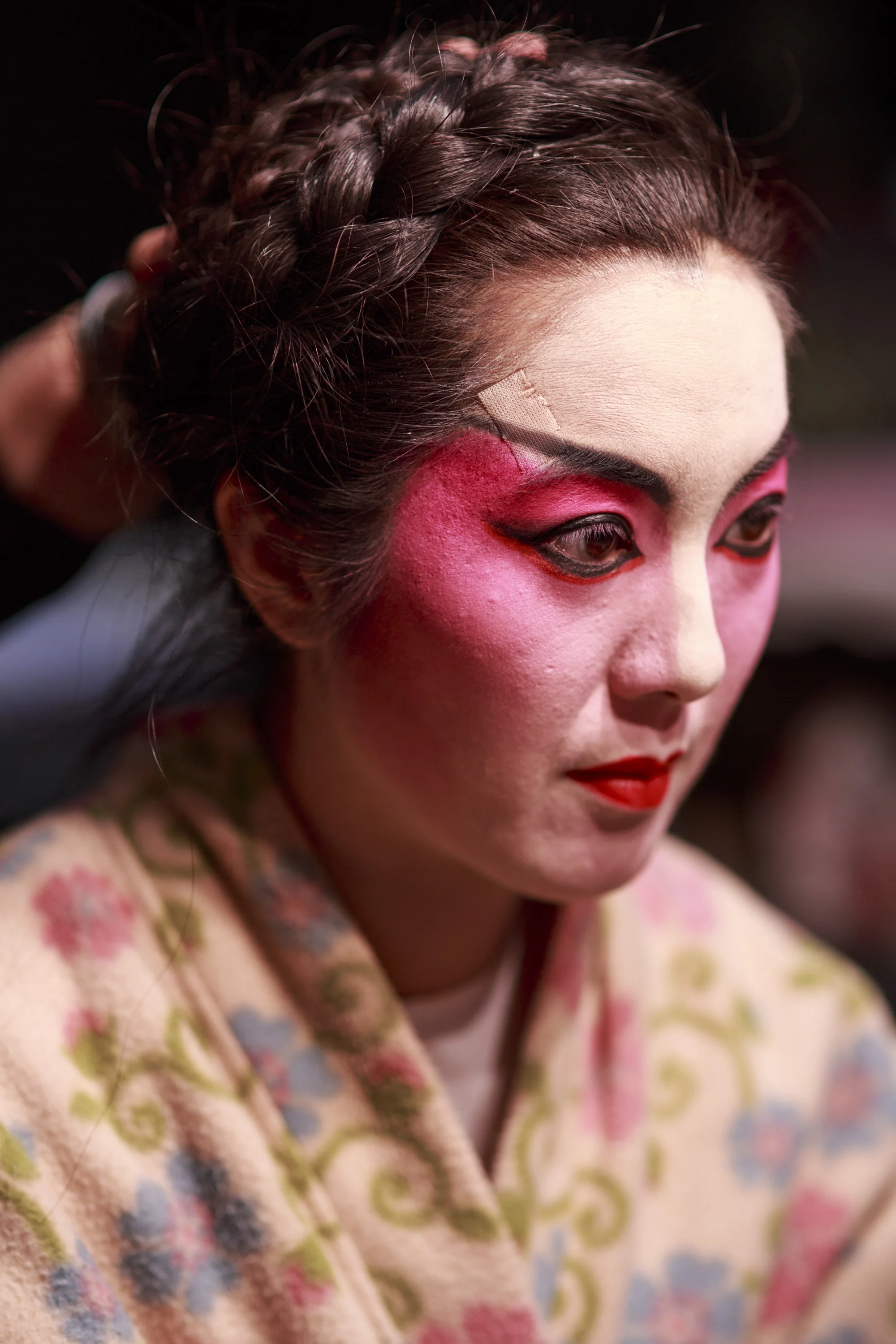  Eliza Li, Chinese Opera singer seen here applying makeup for her performance 
