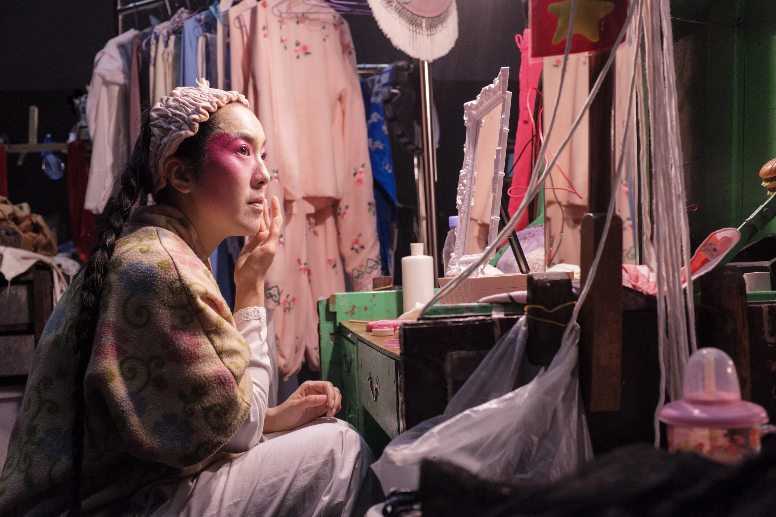  Eliza Li, Chinese Opera singer seen here applying makeup for her performance 