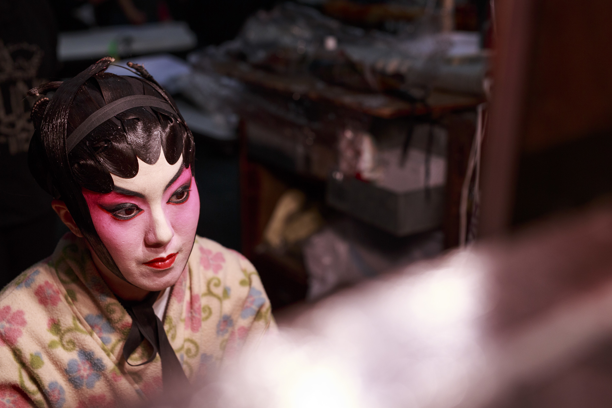  Eliza Li, Chinese Opera singer seen here applying makeup for her performance 