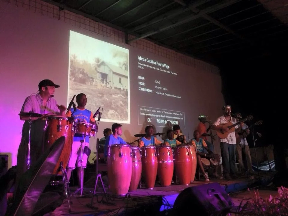 Los Icebreakers perform with Los Rumberitos while photos from the South Caribe Roots Archive display on the screen behind. Hot Rocks, Puerto Viejo, August 2015.