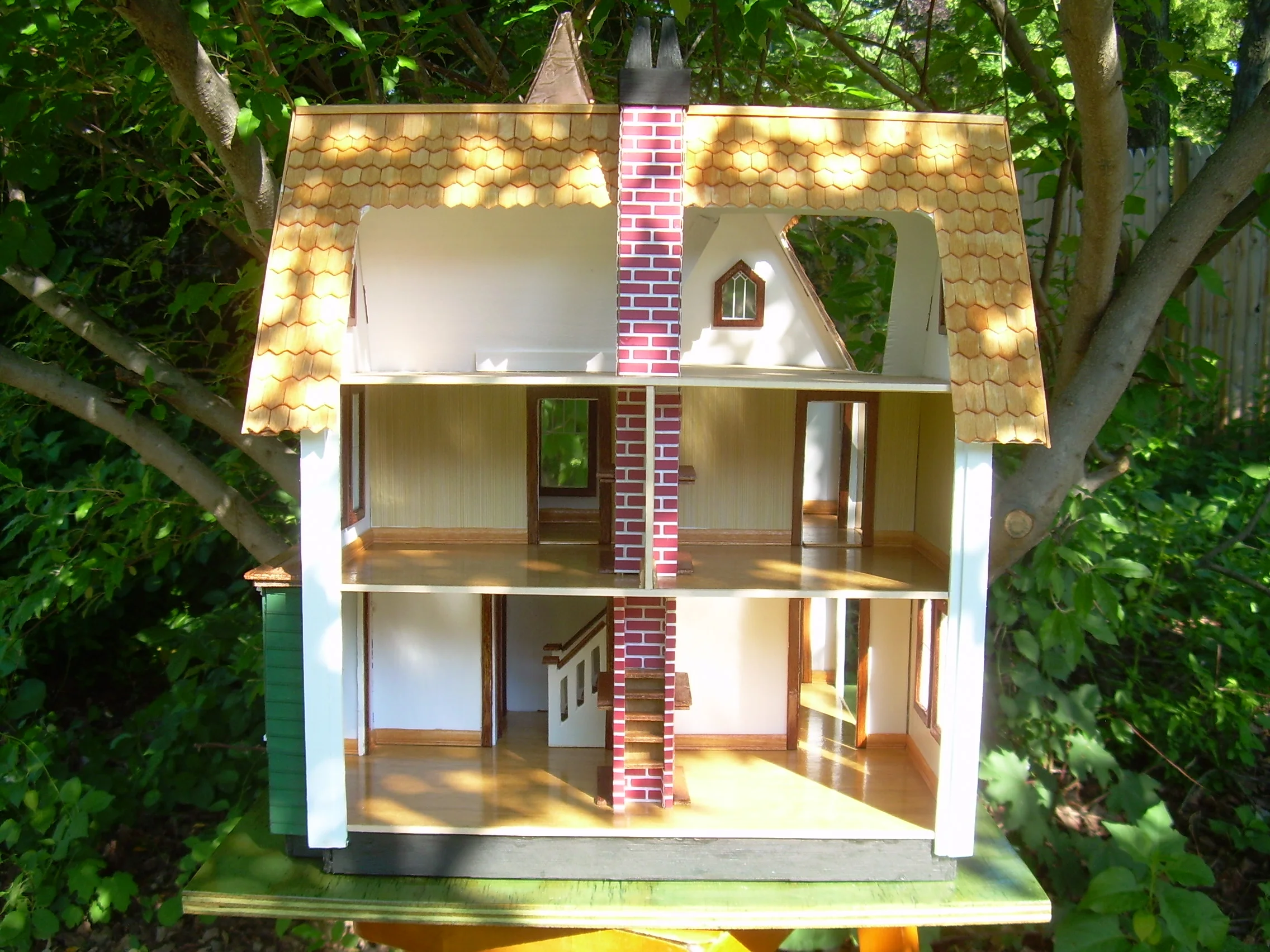 Side view showing living room and dining room downstairs, middle floor rooms and attic