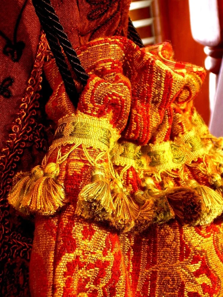 red and gold brocade bag lined with gold tassels