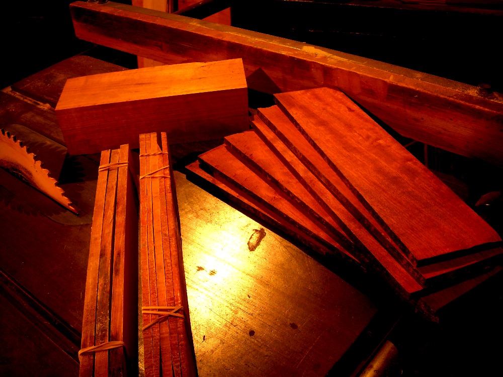various hardwoods in block and resawn by bandsaw and sitting on a table saw