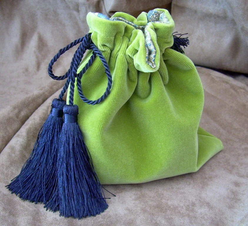 small olive green velvet bag with tassels