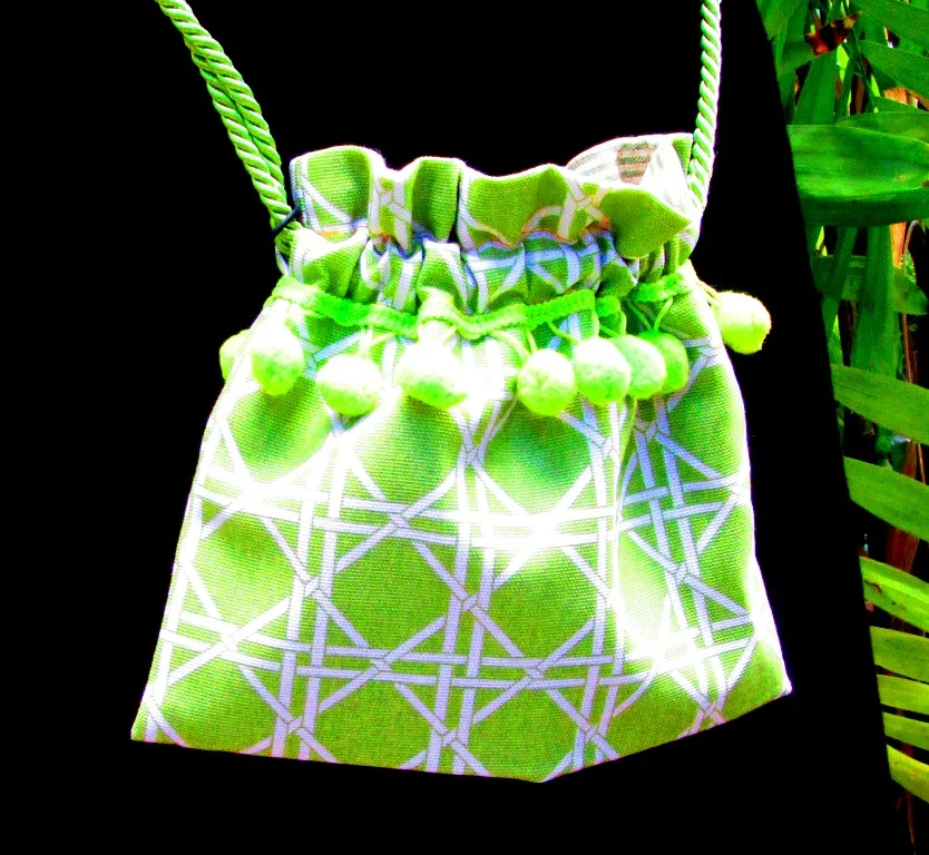 young girls green and white bag with pompoms
