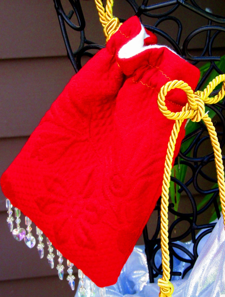 red quilted bag with clear heart beads and white felt lining