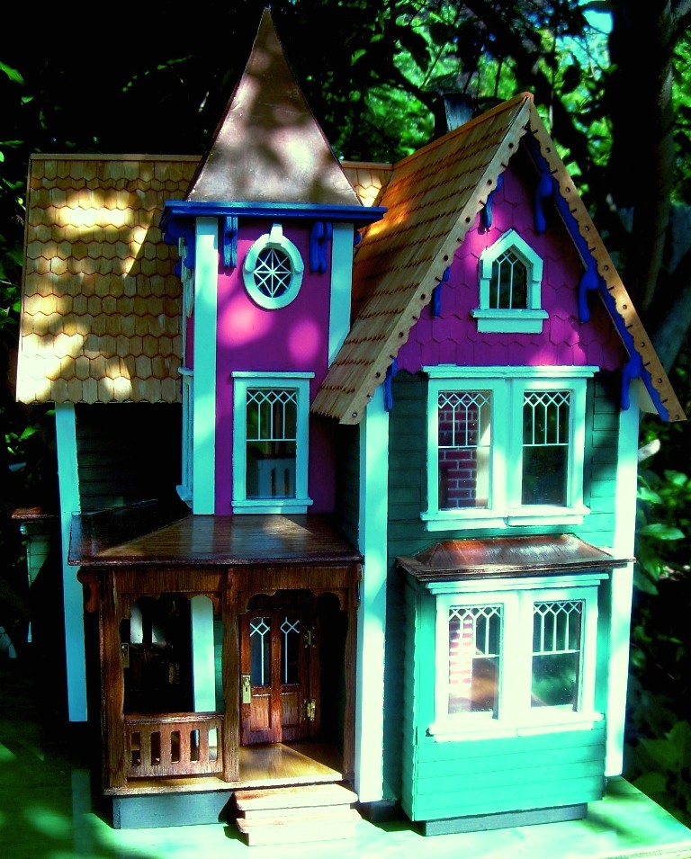 I like taking pictures of the dollhouses outside so they look like a real house and the sun coming through the windows looks terrific.